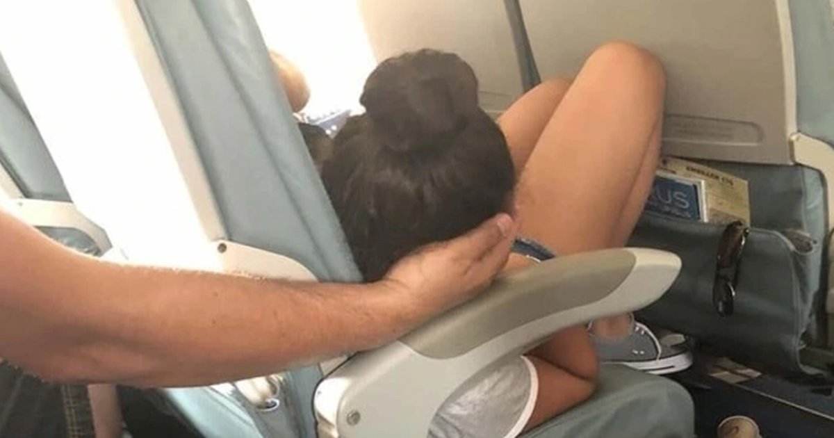 Dad sparks debate holding daughter’s head 45 mins while she slept on flight